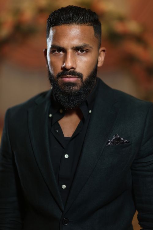 Free A portrait of a confident man in formal attire with a blurred background. Stock Photo