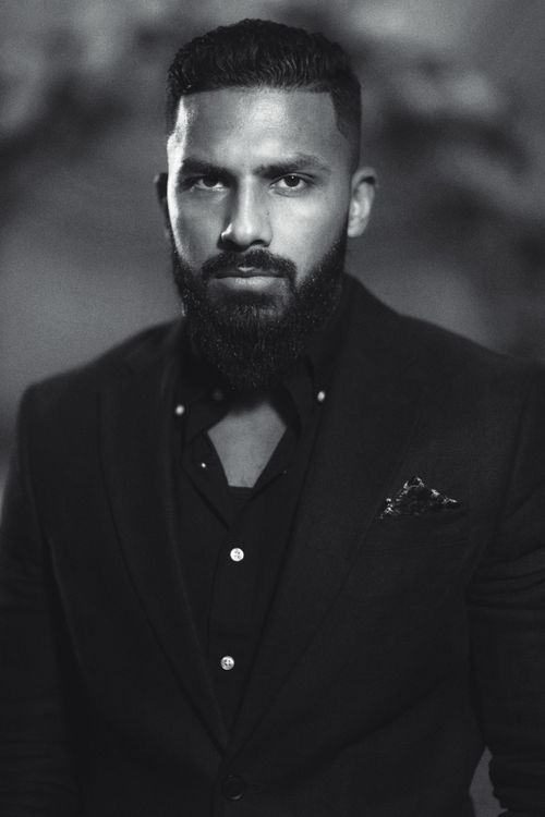 Free Elegant black and white portrait of a bearded man in formal attire. Stock Photo