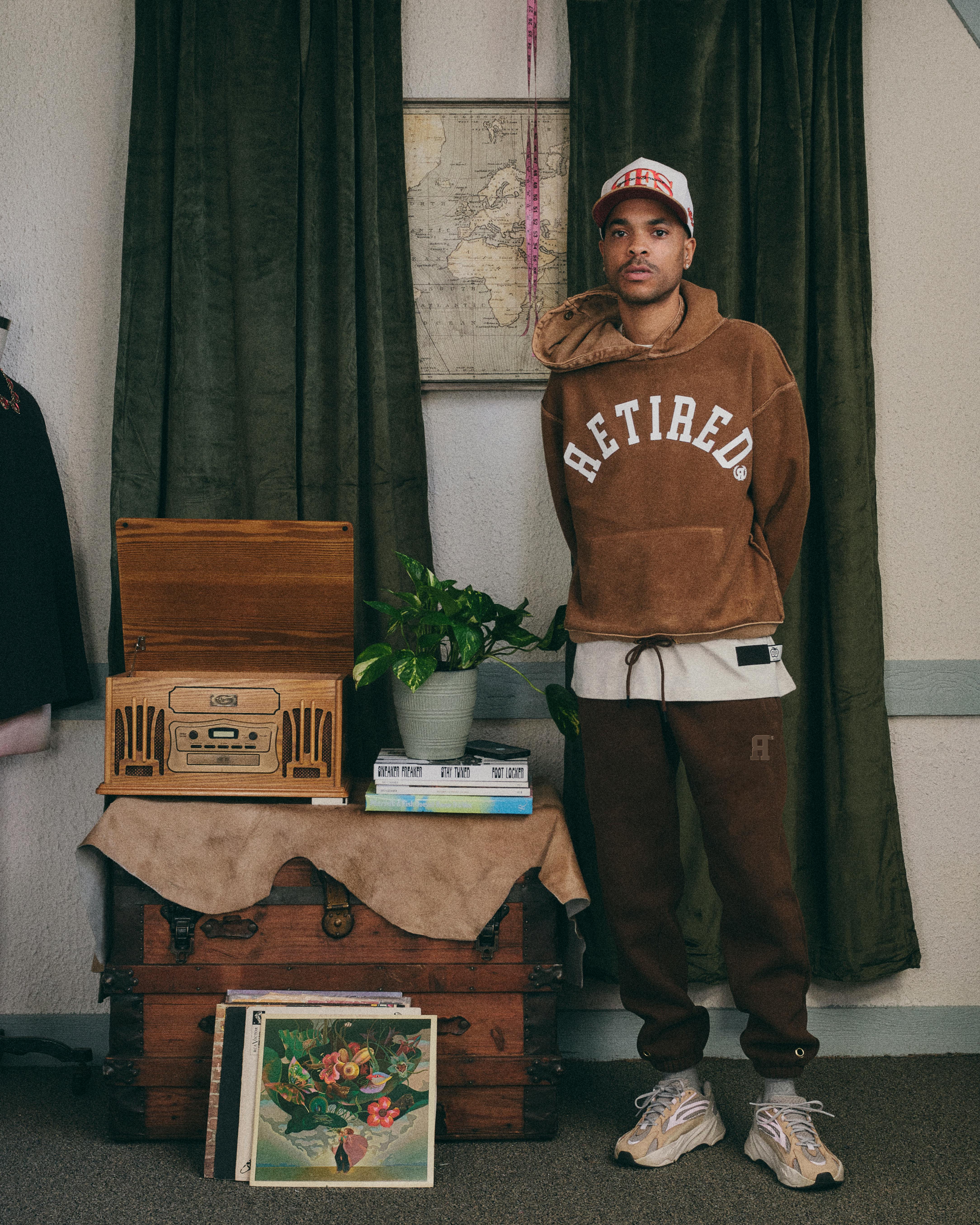 A man in casual fashion stands in a vintage room with retro decor in Midland Park.
