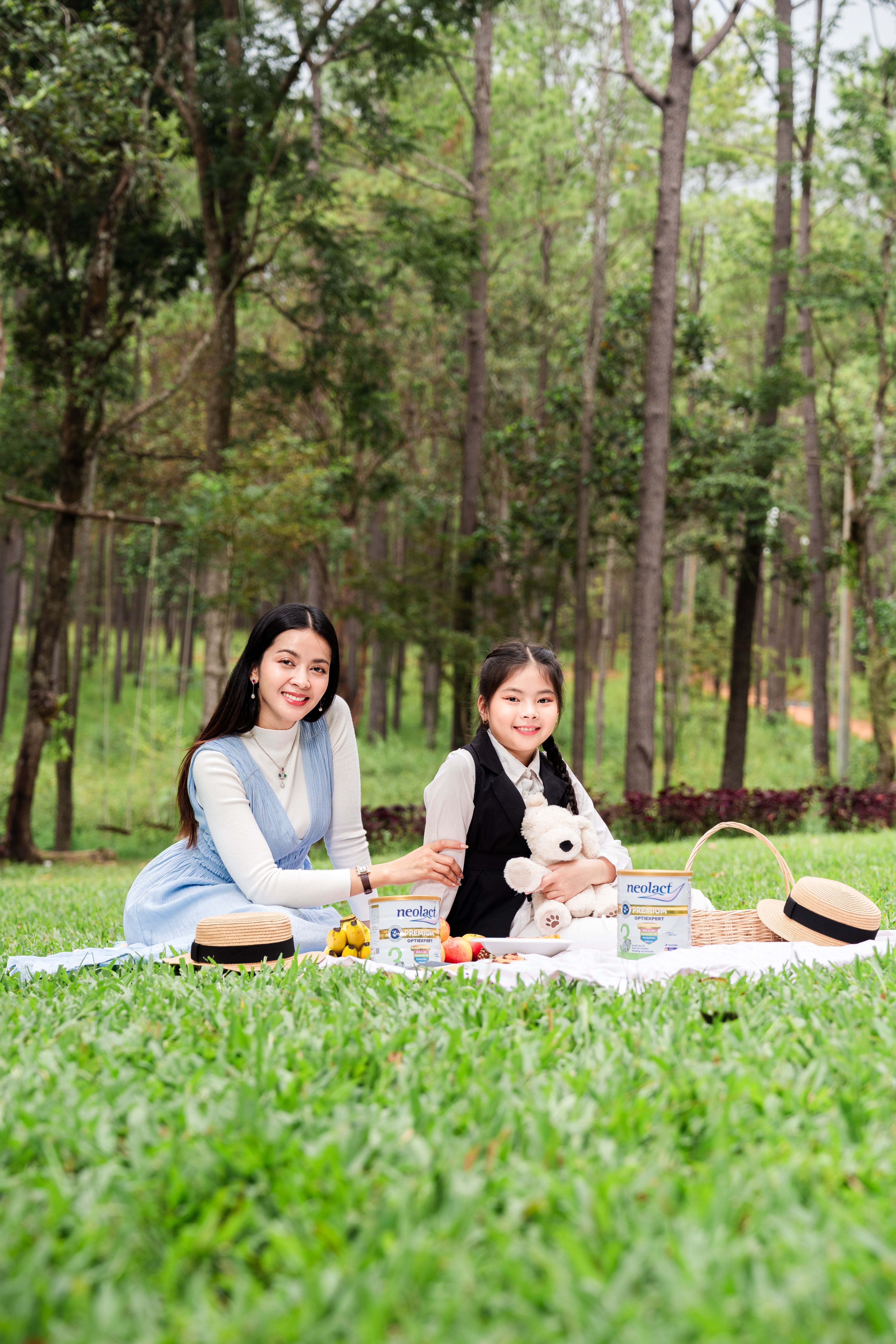 A joyful mother and daughter sharing a picnic in a lush green forest, exuding happiness and love.