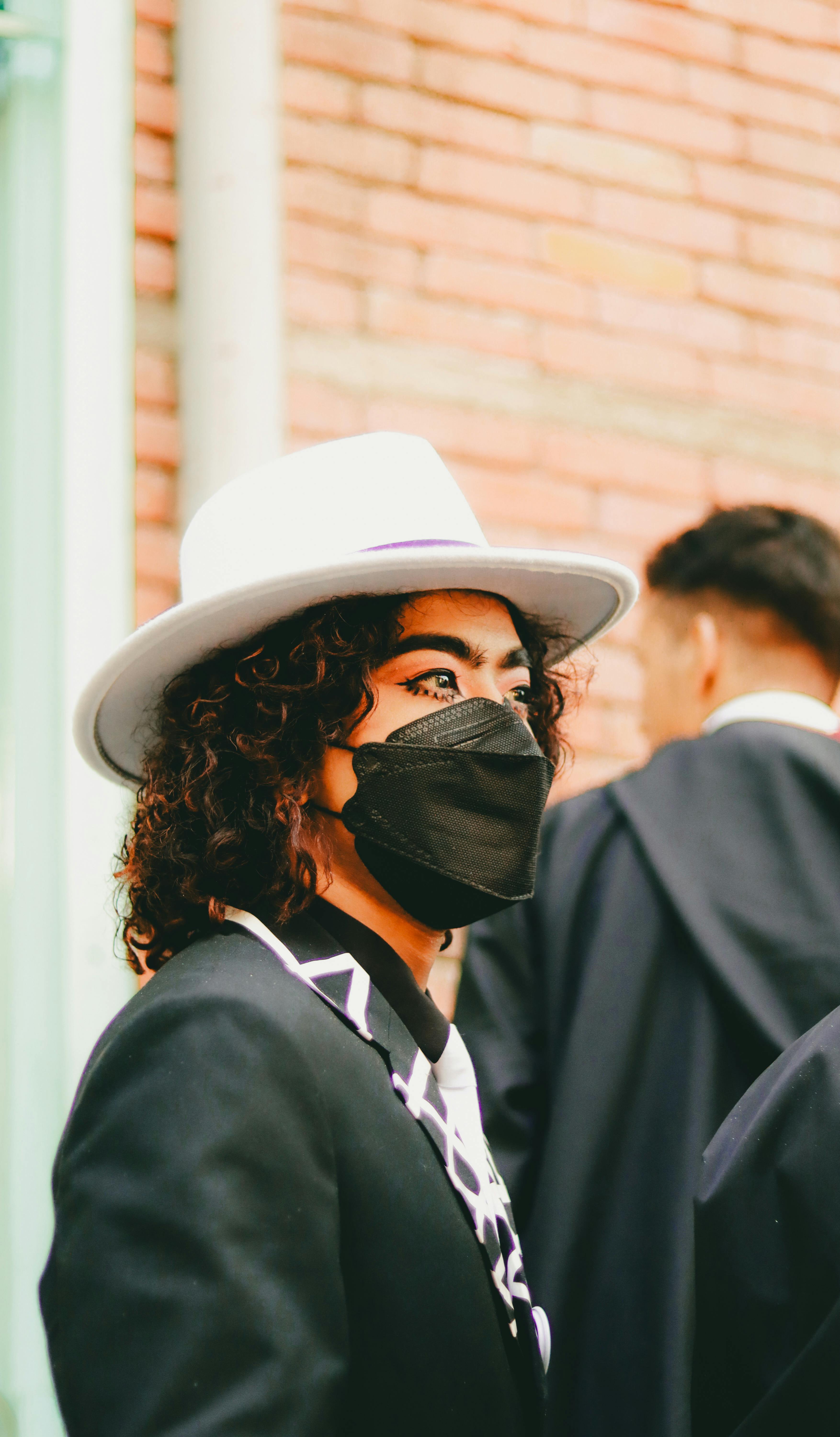 Masked Individual in Formal Attire Outdoors · Free Stock Photo