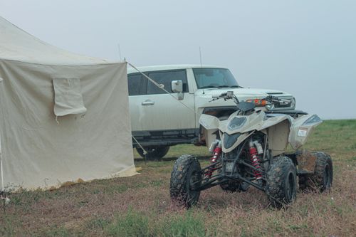 Free Explore Saudi Arabia's desert landscape with an off-road vehicle, tent, and rugged nature. Stock Photo