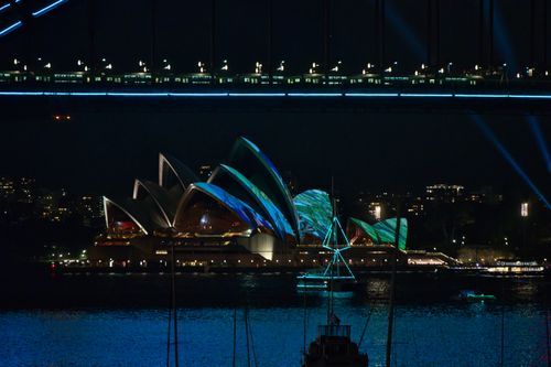 Free Sydney Opera House brightly illuminated during Vivid Sydney festival at night. Stock Photo
