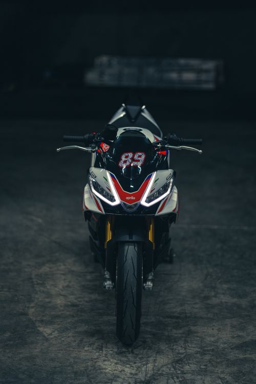 Free A high-performance Aprilia motorcycle showcased in a dark, moody atmosphere. Stock Photo