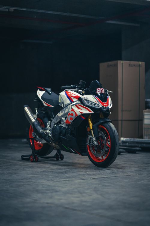 Free Capture of a sporty Aprilia motorcycle showcasing sleek design in a garage. Stock Photo