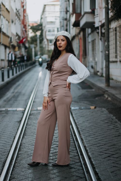 Free Young woman in fashionable outfit posing confidently on a tram street in Istanbul. Stock Photo