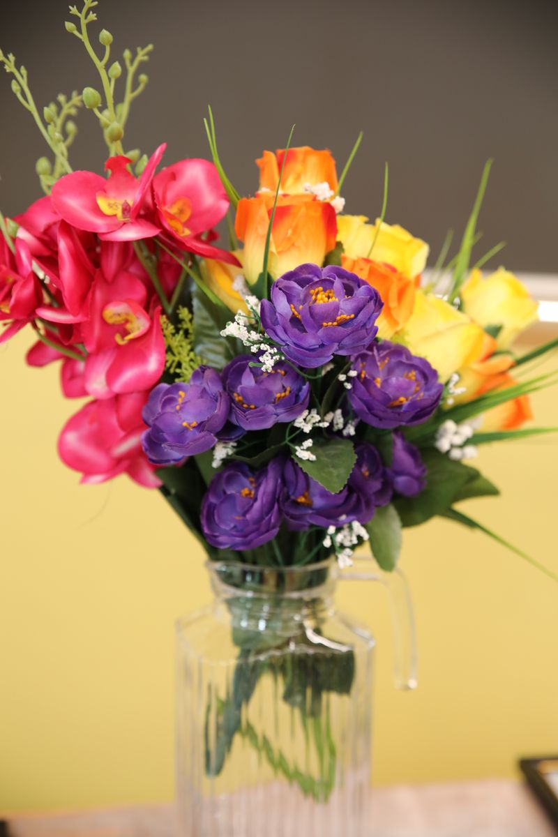 A beautifully arranged bouquet of colorful flowers in a glass vase, perfect for brightening any room.