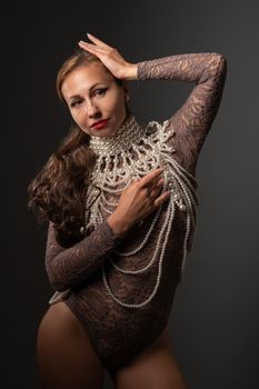 Sophisticated portrait of a woman in lace bodysuit adorned with pearls.