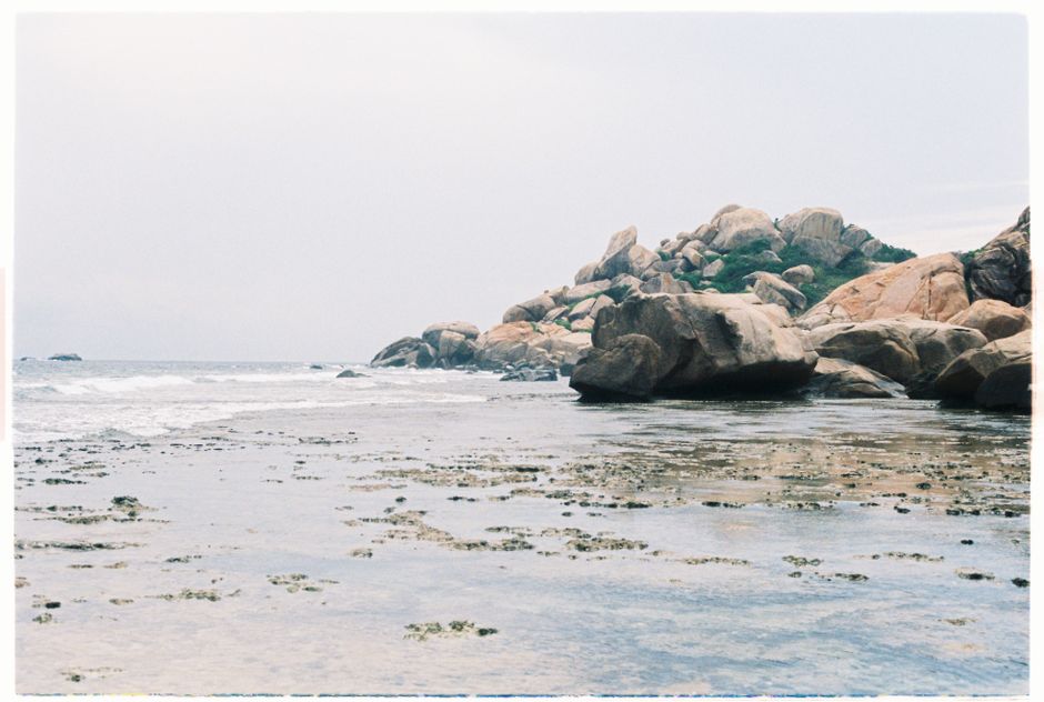 Rocky shoreline with calm gentle waves forming a natural pool