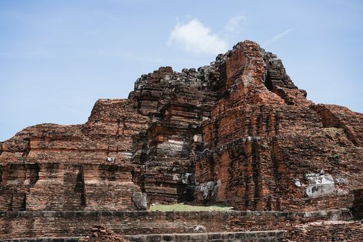 Explore ancient red brick temple ruins, showcasing historic architecture under a clear blue sky.