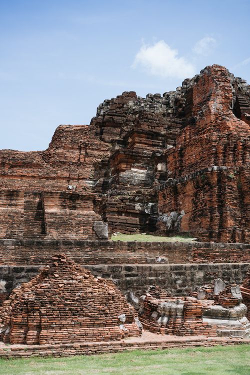 Free Explore the historic red brick ruins of an ancient temple in Thailand under a clear blue sky. Stock Photo