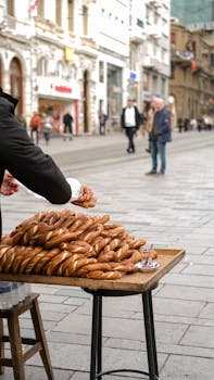 A street vendor sells simit bread at a busy pedestrian street in Istanbul, Turkey.