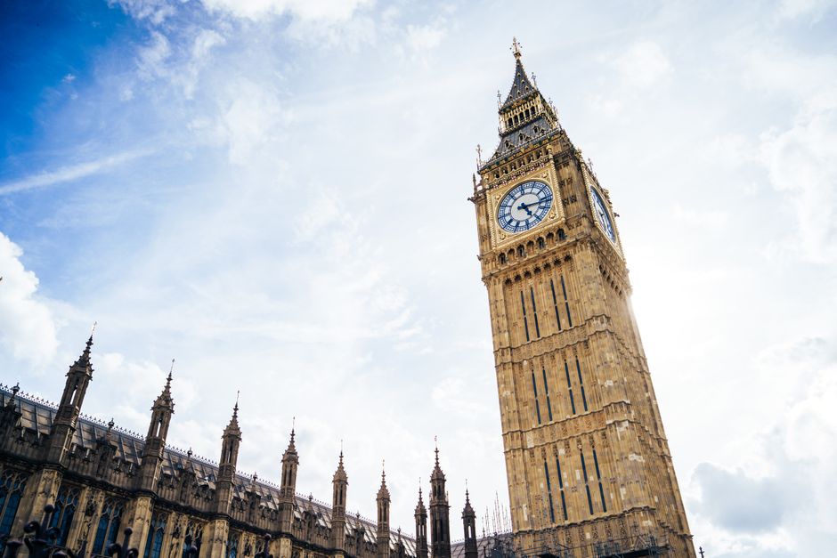 Iconic Big Ben tower set against a vibrant blue sky in London, capturing the essence of British architecture.