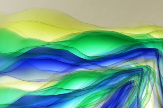Colorful abstract art depicting vibrant waves in green and blue tones.