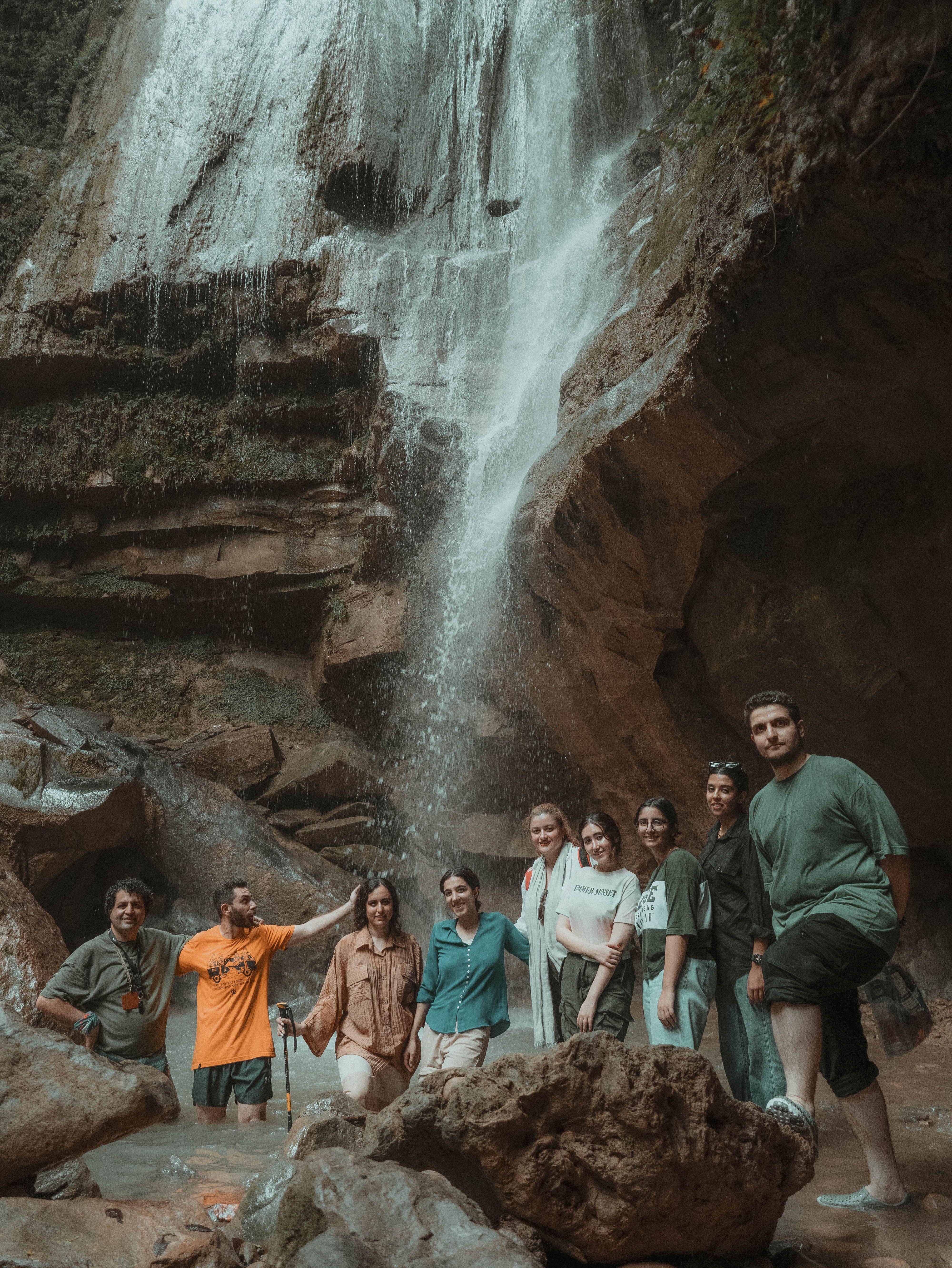 Group Enjoying Nature at Scenic Waterfall · Free Stock Photo
