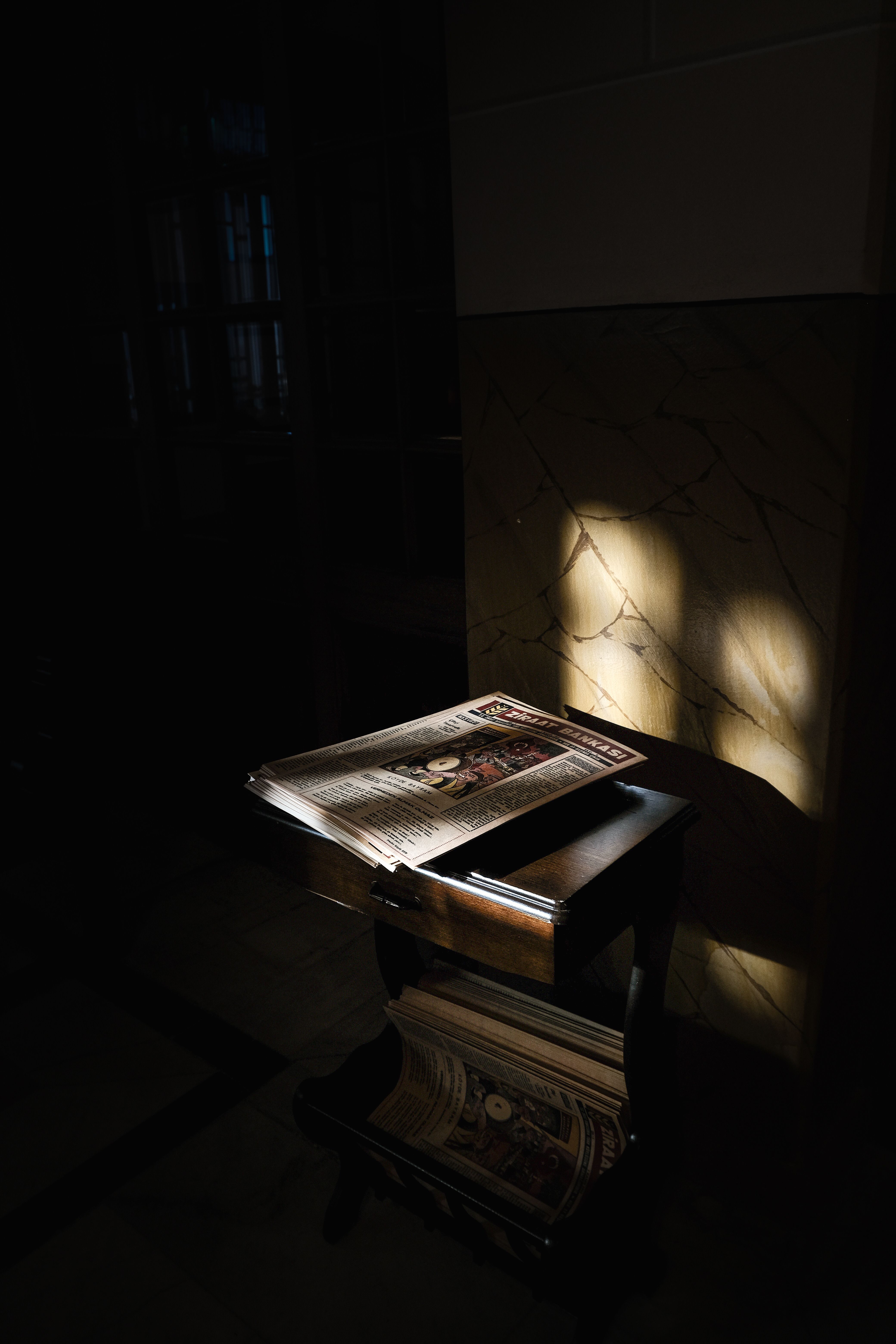 Dramatic Light on Open Magazine Indoors · Free Stock Photo