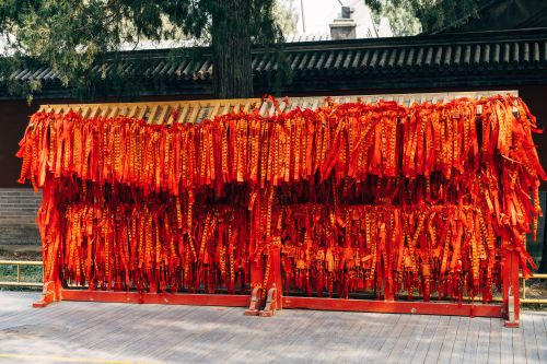 Free Bright red traditional ribbons hanging in a vibrant display, symbolizing culture and celebration. Stock Photo
