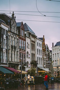 A lively streetscape with historic European buildings and bustling street life.