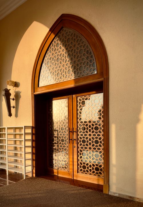 Free Beautiful Arabic wooden door with intricate patterns in Dubai at sunrise. Stock Photo