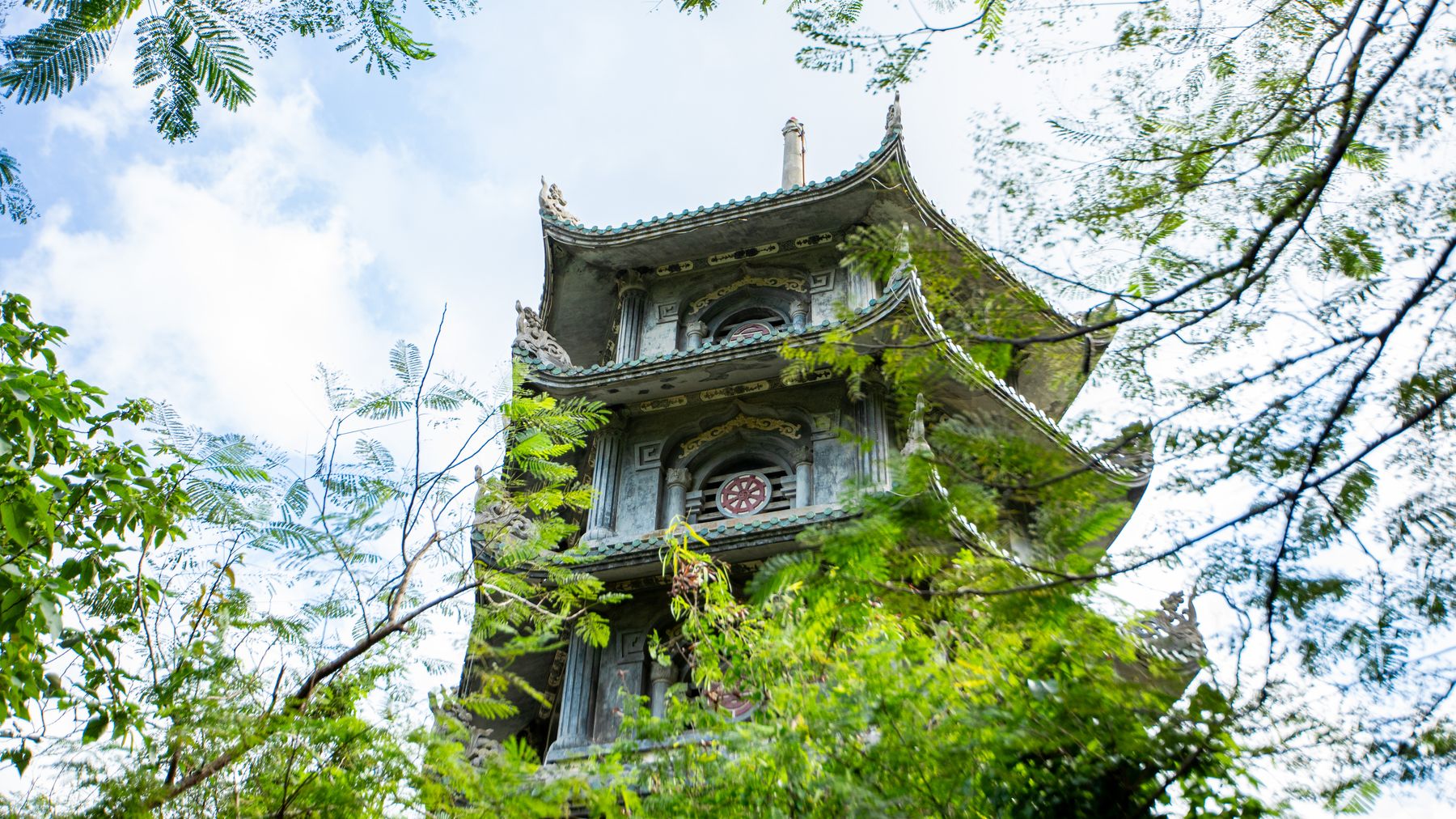Ancient pagoda surrounded by lush greenery in Marble Mountains, Da Nang, Vietnam.