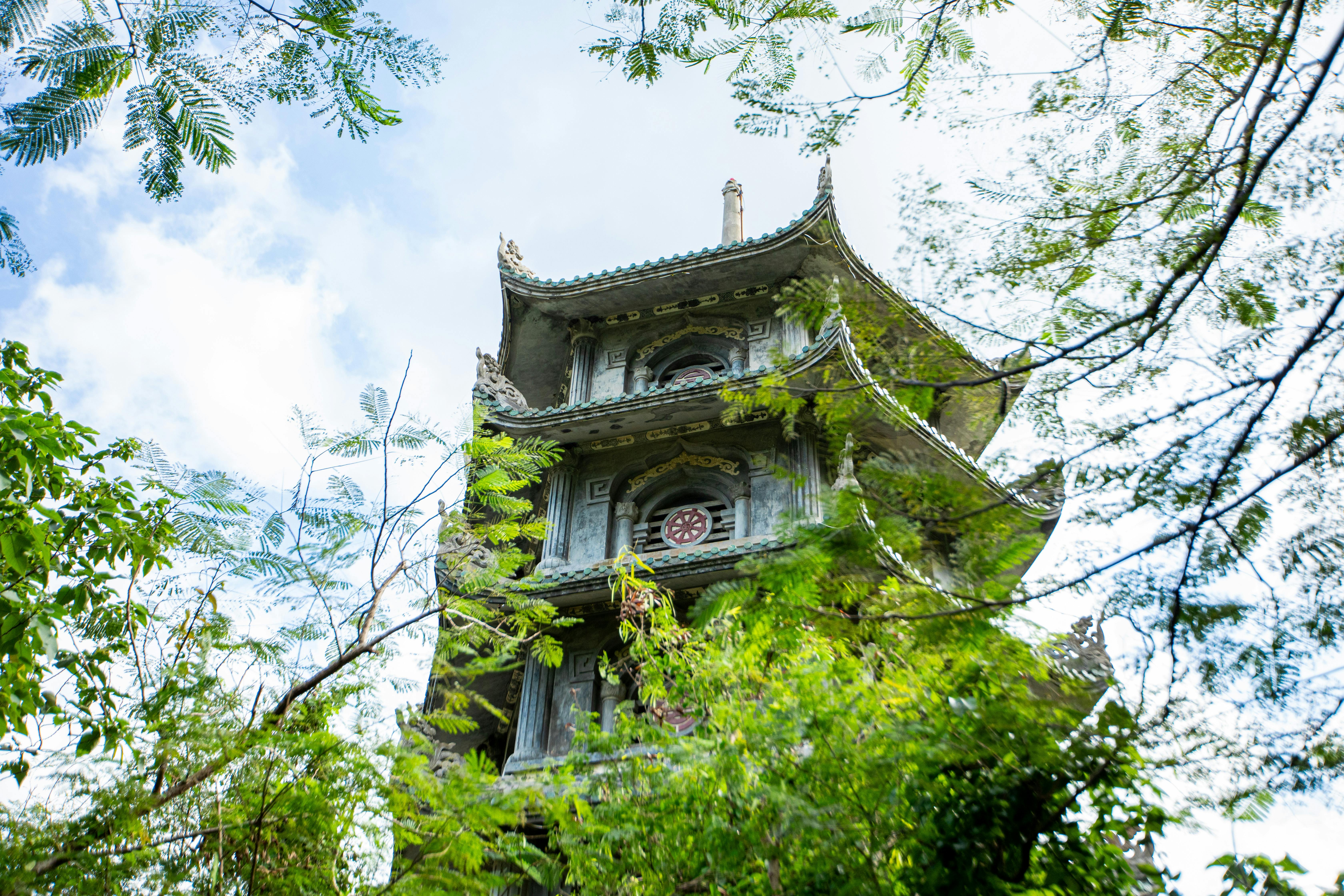 Free Ancient pagoda surrounded by lush greenery in Marble Mountains, Da Nang, Vietnam. Stock Photo