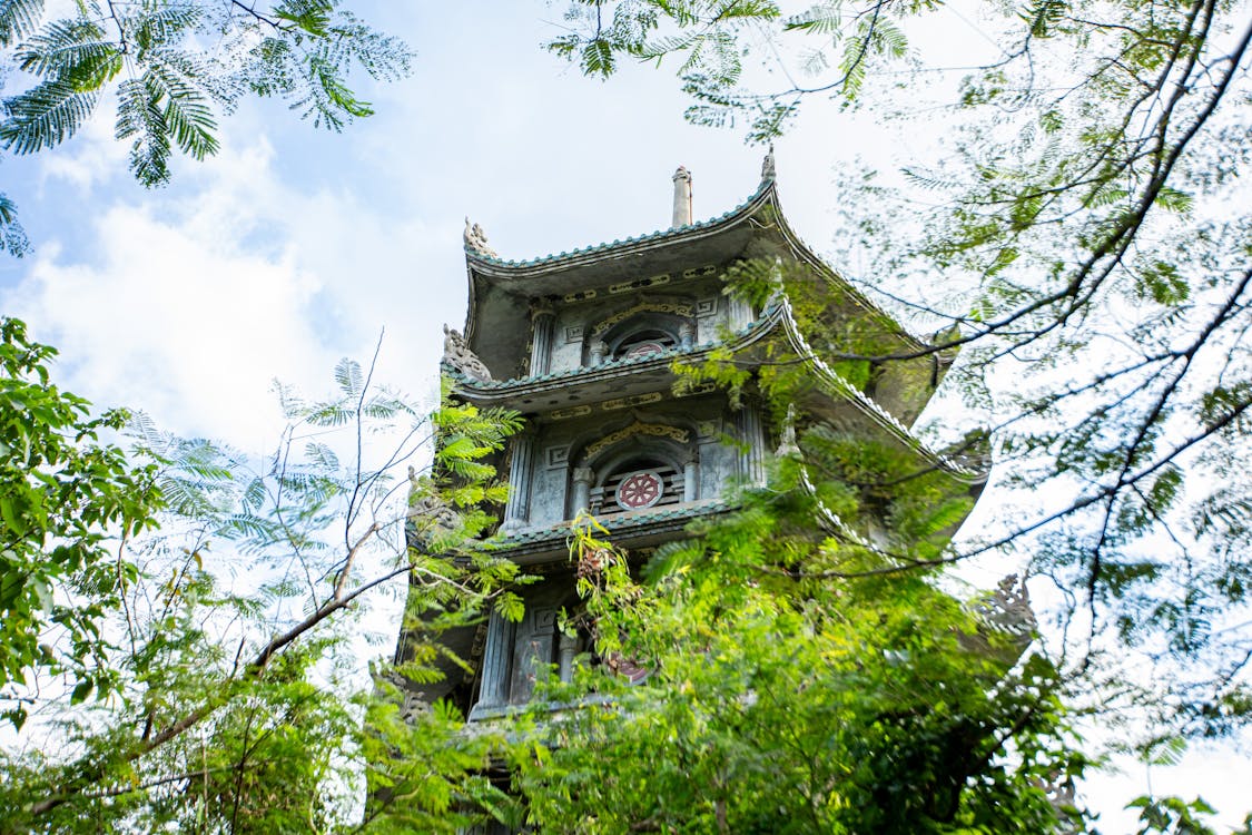 Free Ancient pagoda surrounded by lush greenery in Marble Mountains, Da Nang, Vietnam. Stock Photo