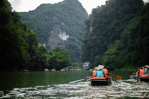 Free Explore the lush greenery and karst formations of Trang An, Ninh Bình, by boat. Stock Photo