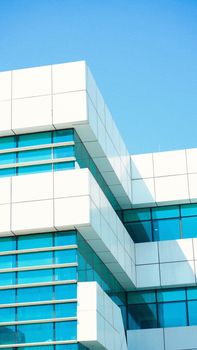 A striking image showcasing a modern building with blue tinted windows, emphasizing geometric design.