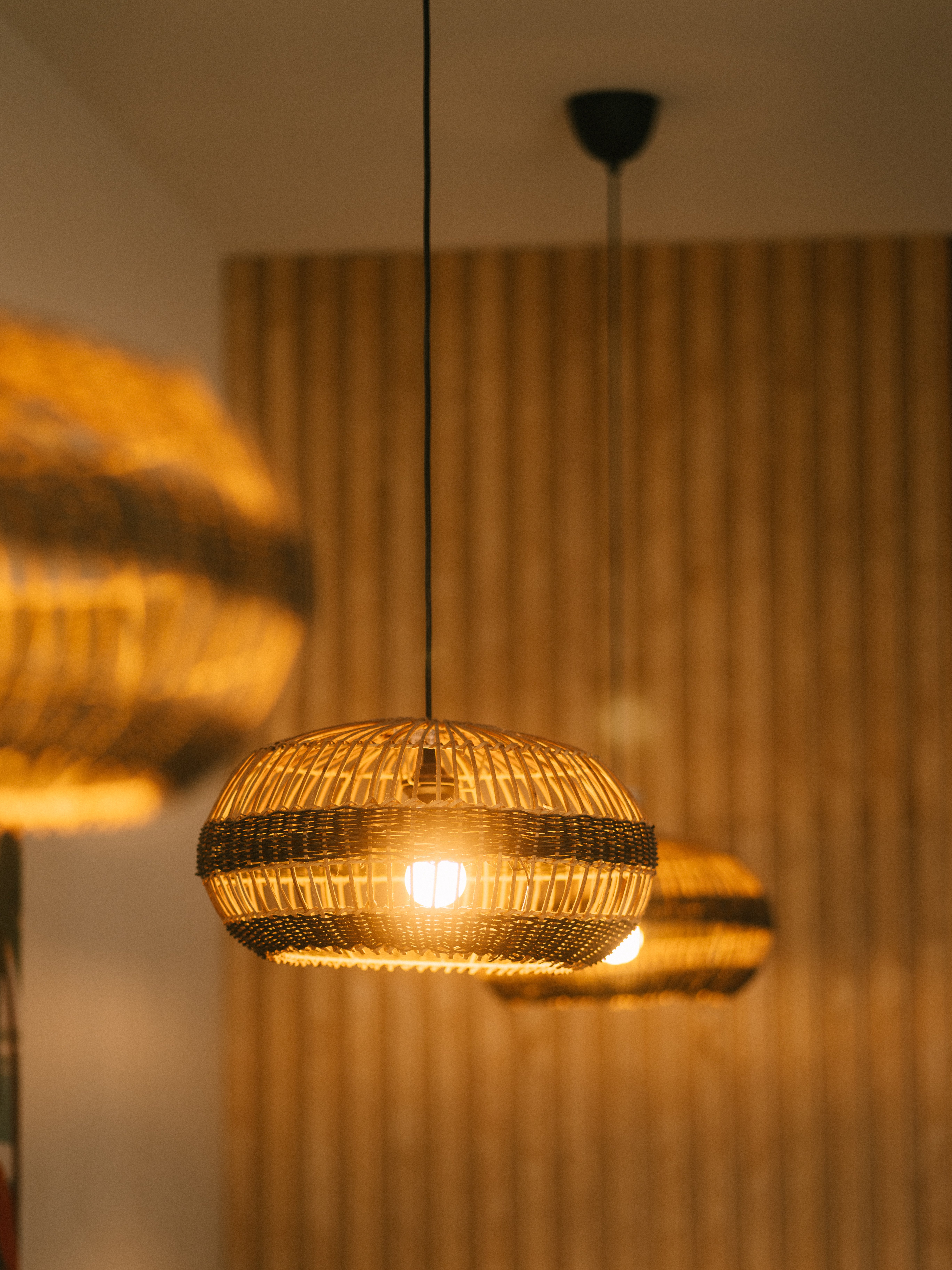 Elegant pendant lights create a warm, inviting ambiance in a modern restaurant setting in Houston.