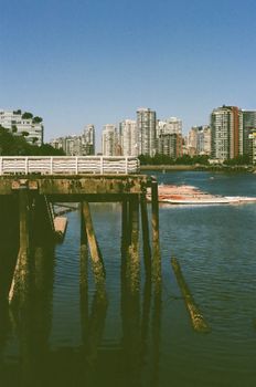Serene view of a city skyline with a waterfront and pier, ideal for travel and landscape themes.