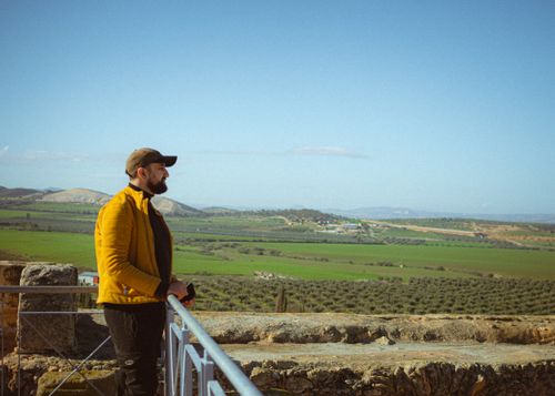 Free Man enjoying panoramic view from historical site in Tunisia. Stock Photo