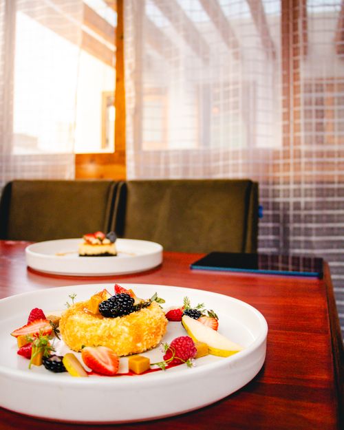 Free A delightful dessert with fresh fruits served on a wooden table indoors. Stock Photo