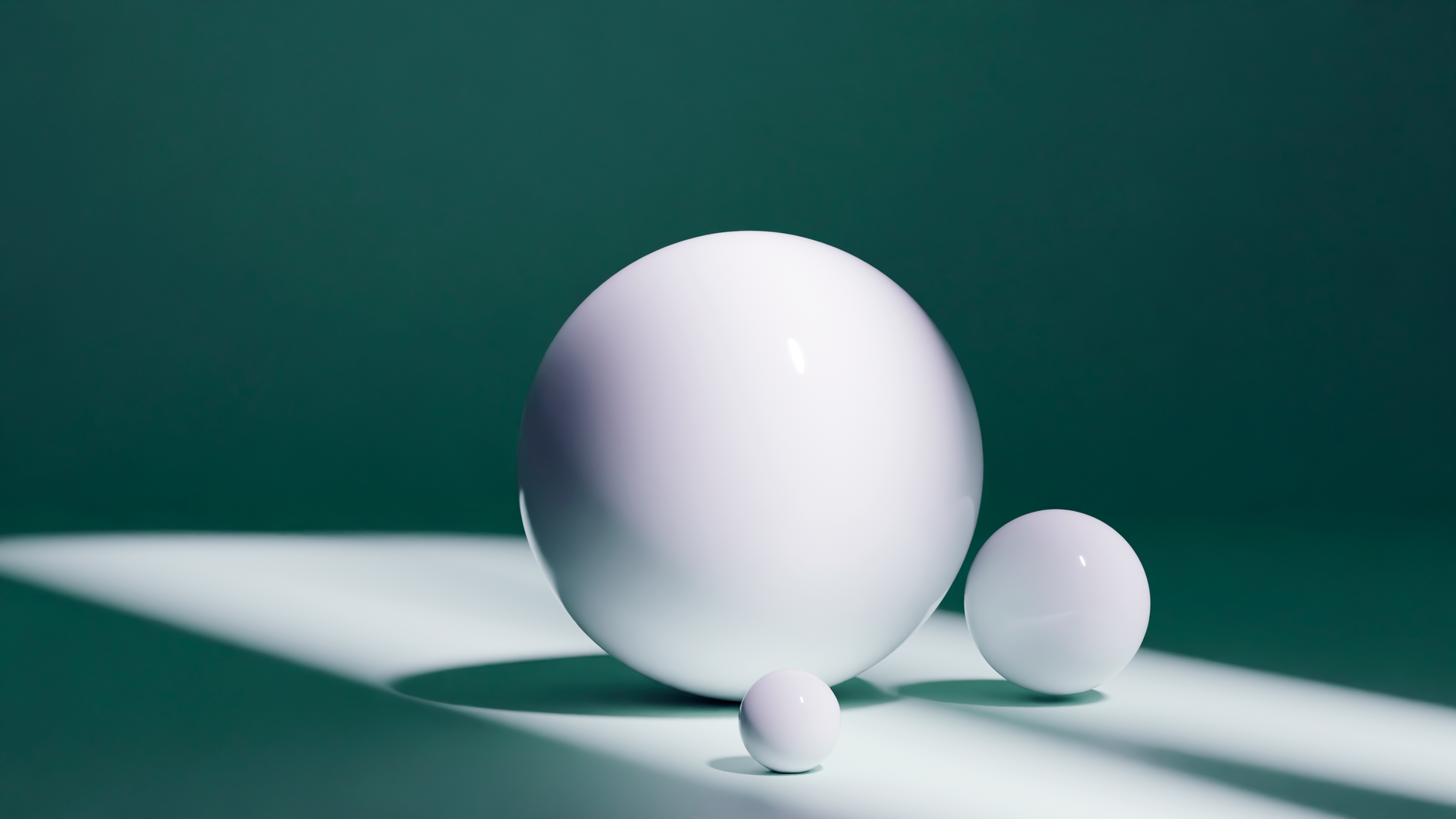 Abstract composition of three white spheres with shadows on a green backdrop.