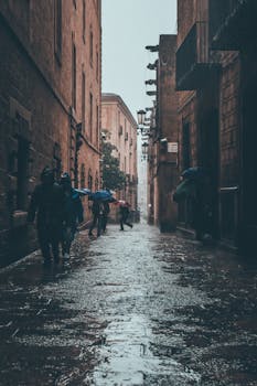 Moody view of a rainy day in the bustling Gothic Quarter of Barcelona, Spain.