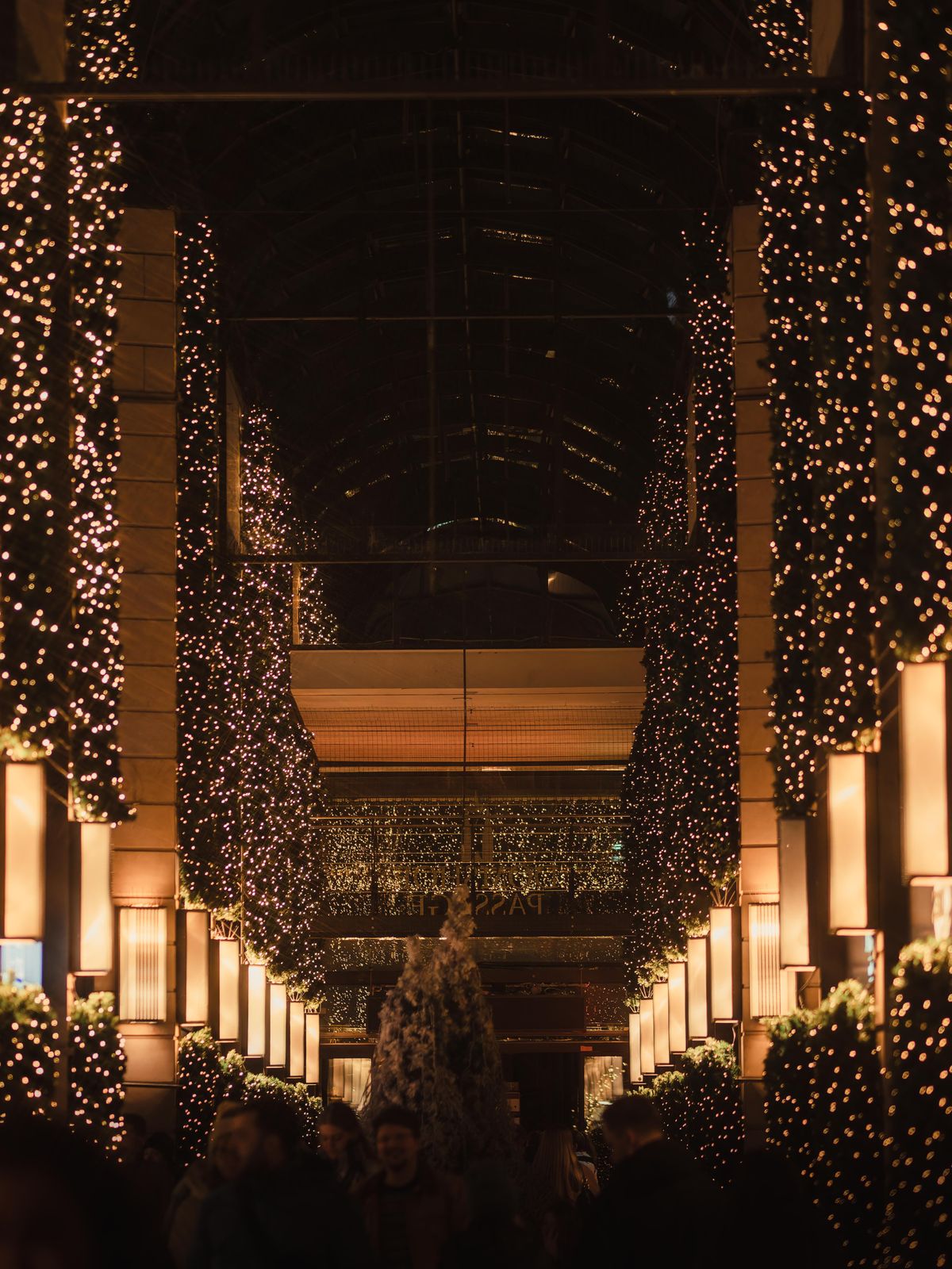 Festive string lights illuminating a corridor at night