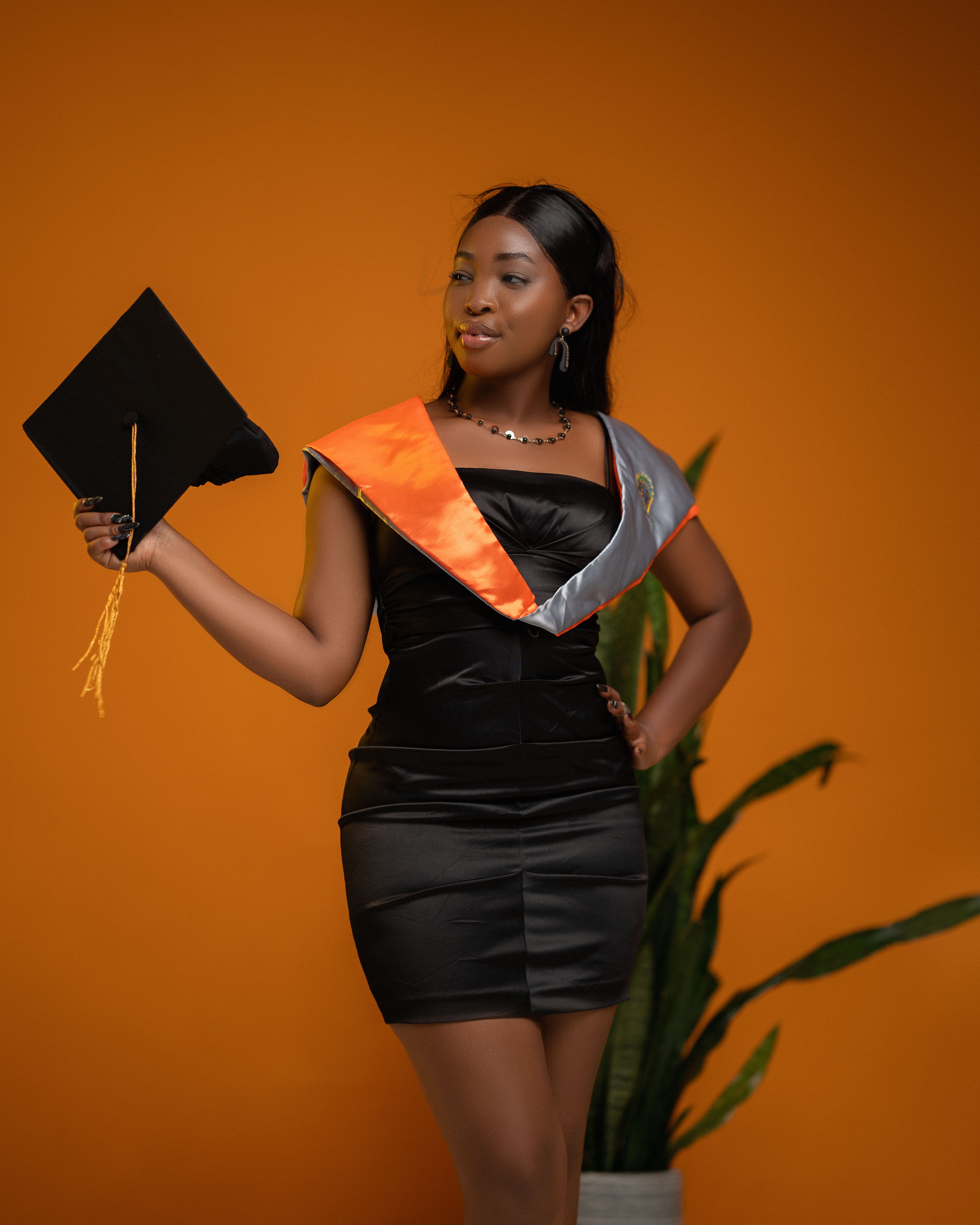 Elegant Graduation Portrait with Cap and Gown  Free Stock Photo