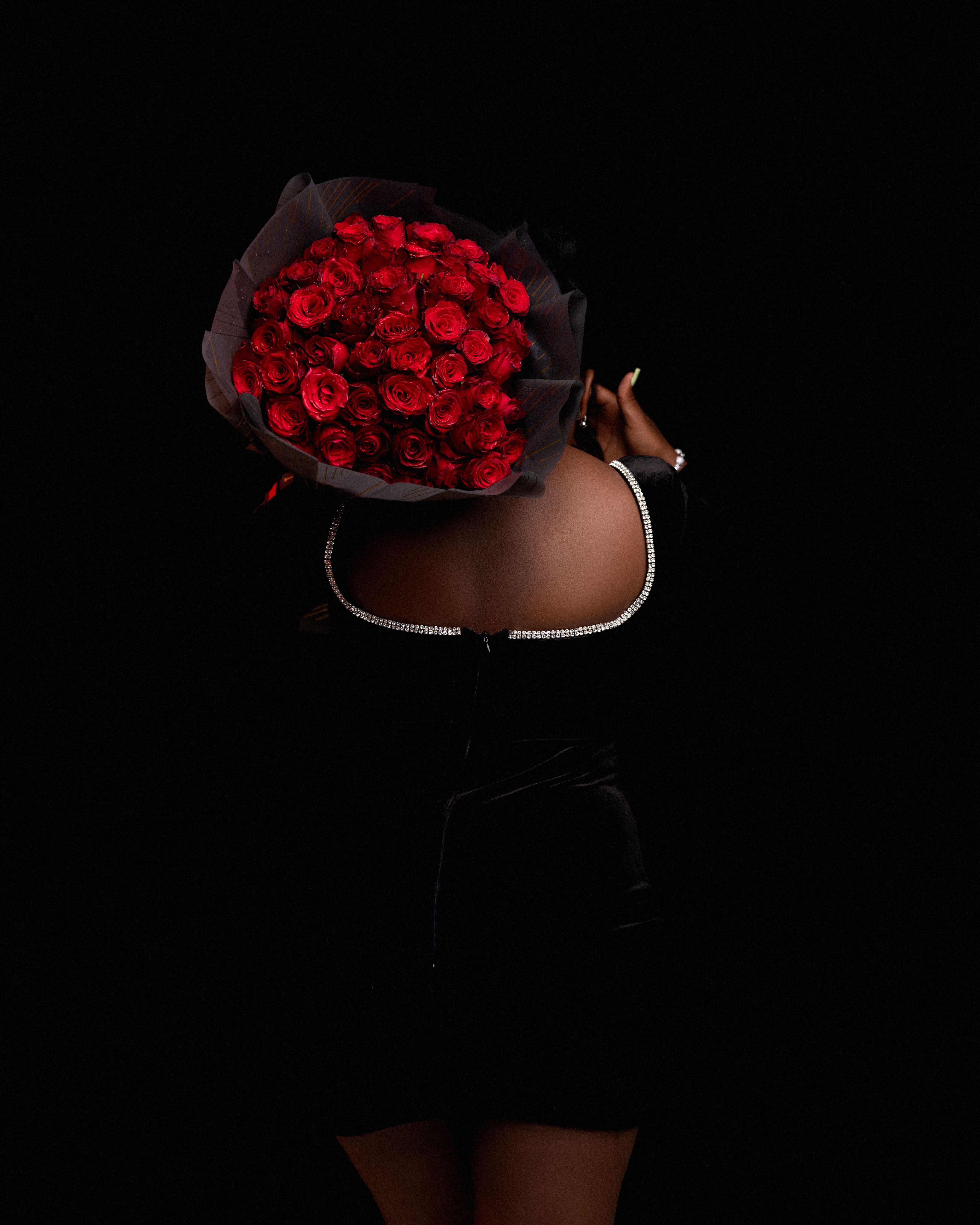 Elegant Woman Holding Bouquet of Red Roses · Free Stock Photo