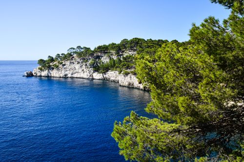Free Scenic coastal landscape of Calanques in Marseille, France with clear blue waters and lush greenery. Stock Photo