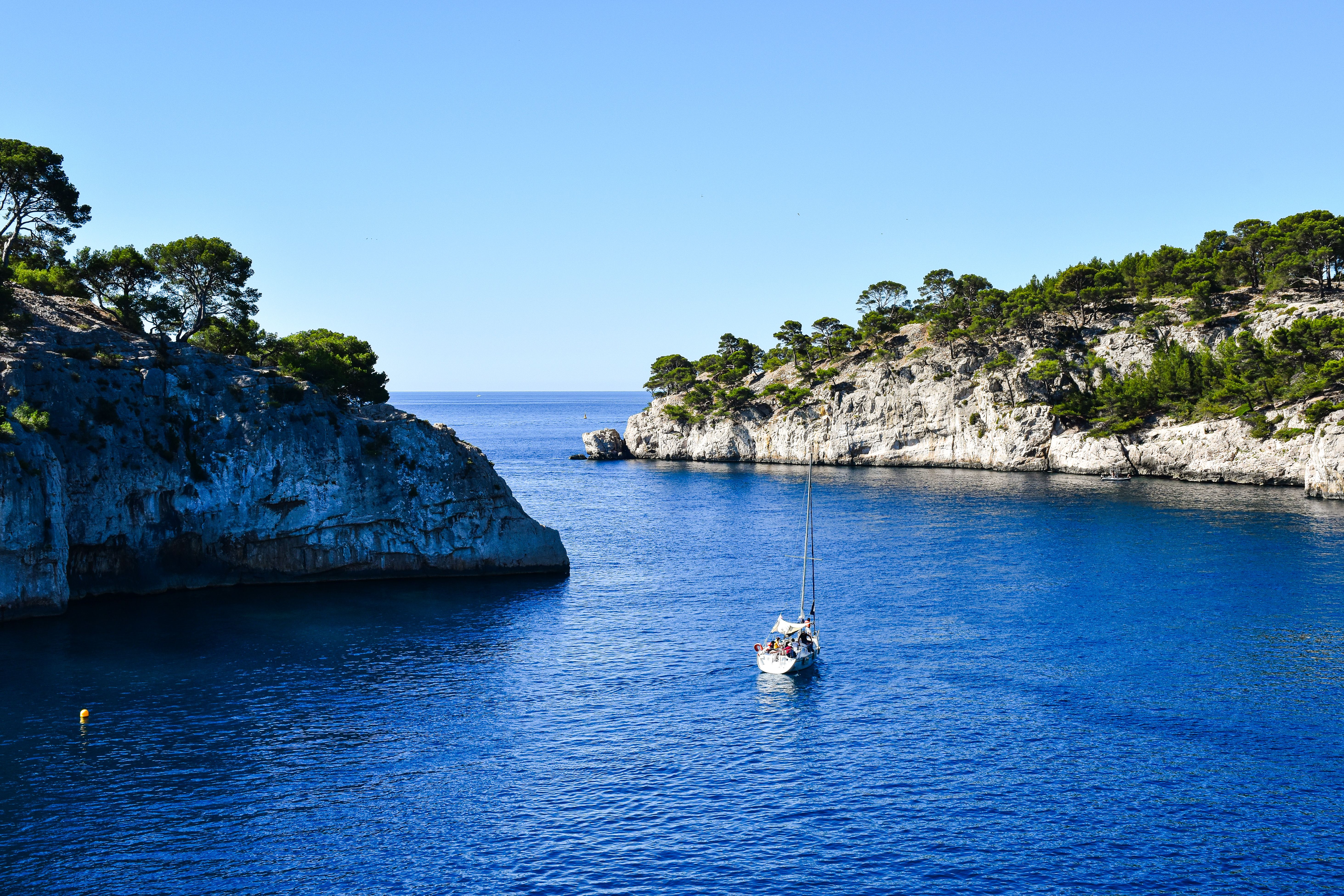 Explore the stunning calanques with a sailboat in clear blue waters of Provence-Alpes-Côte d'Azur, France. Explore the stunning calanques with a sailboat in clear blue waters of Provence-Alpes-Côte d'Azur, France.