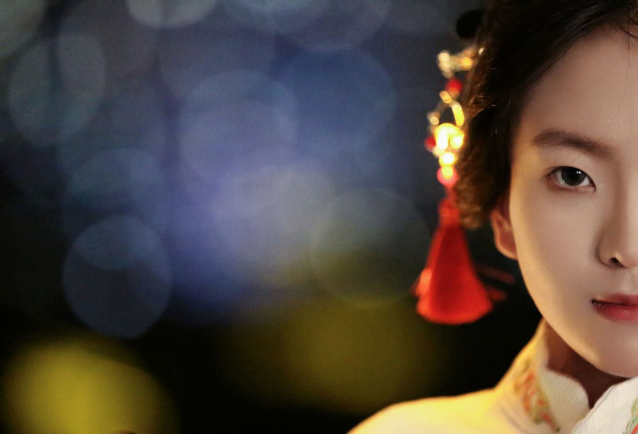 half portrait of a woman in traditional asian clothing with soft focus