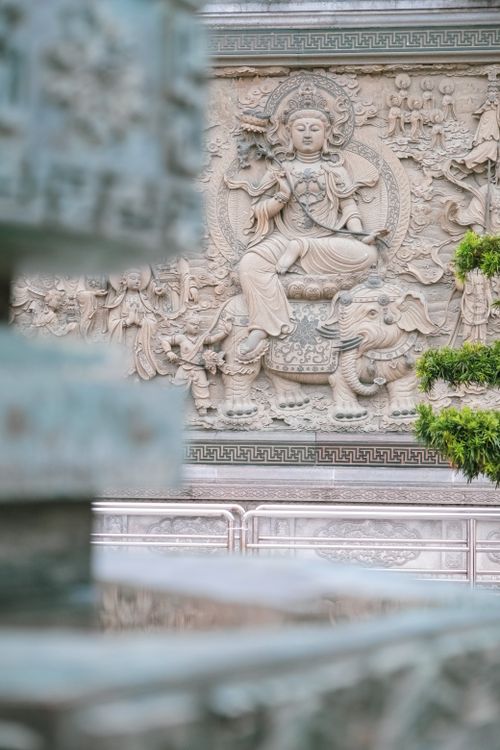 Free Breathtaking stone relief depicting a Buddhist deity in a temple setting, showcasing intricate artistry. Stock Photo
