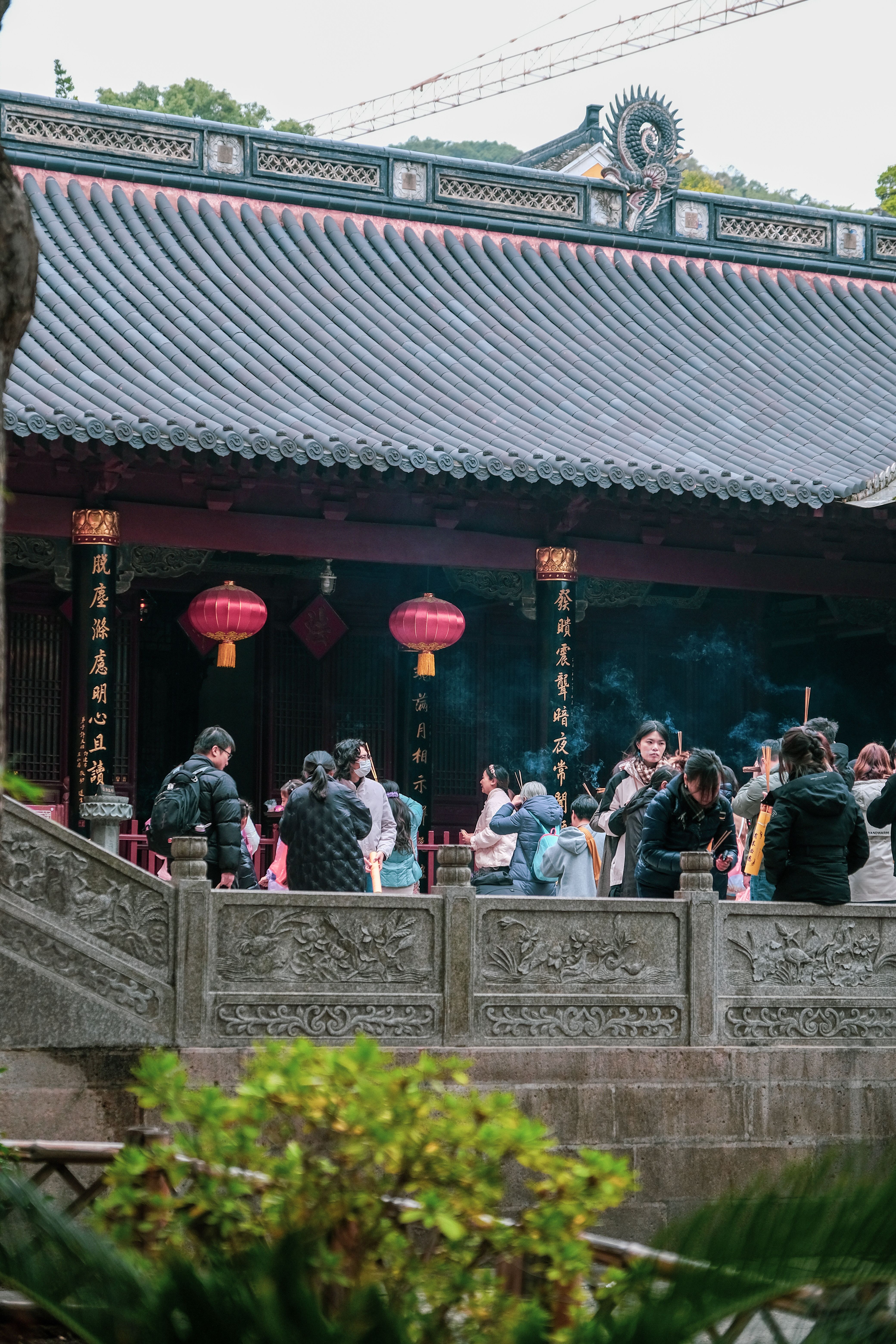 Visitors Gather at Traditional Asian Temple · Free Stock Photo