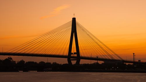 Free A stunning silhouette of Anzac Bridge framed against a vibrant sunset sky in Sydney, Australia. Stock Photo
