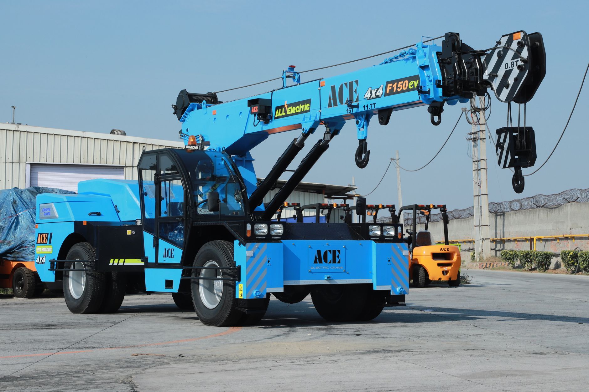 Electric ACE F150EV crane displayed outdoors in an industrial yard in India.