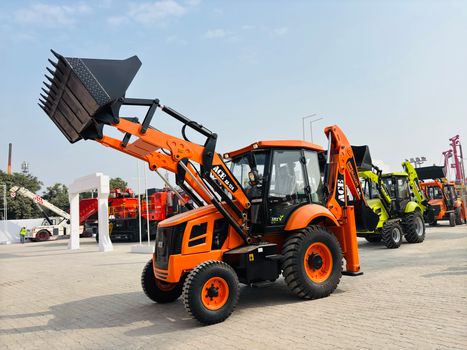 ACE AX 124 backhoe loader displayed outdoors in India.