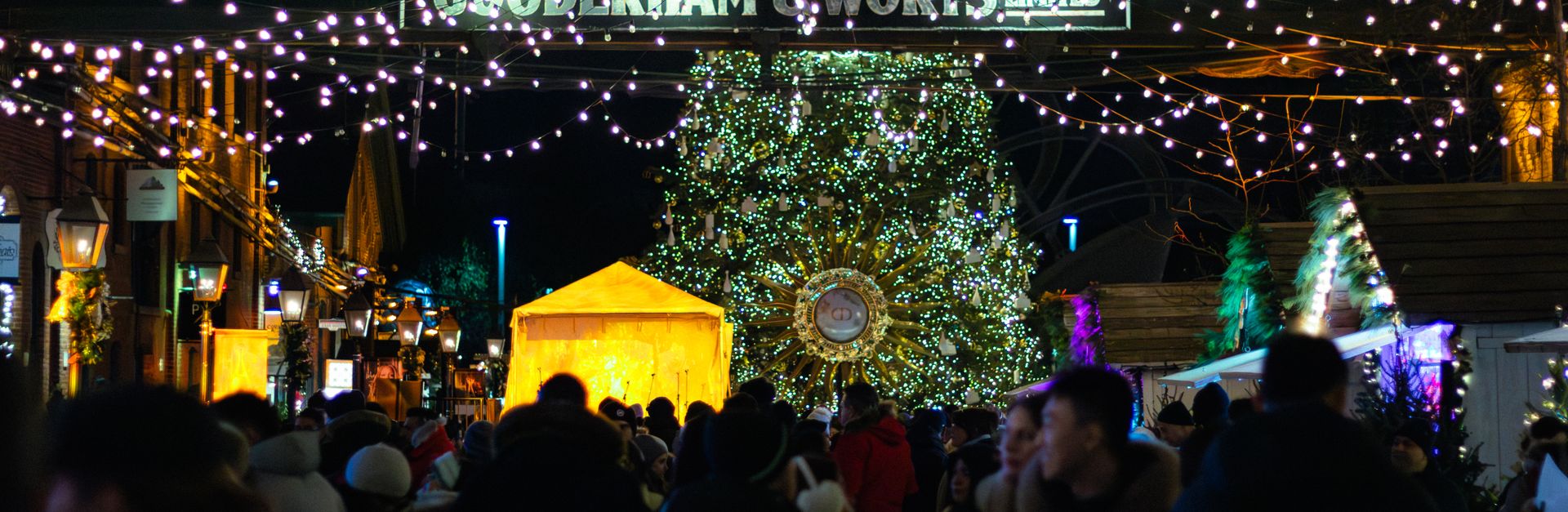 Christmas market bustle in Toronto with lights and festive decorations.