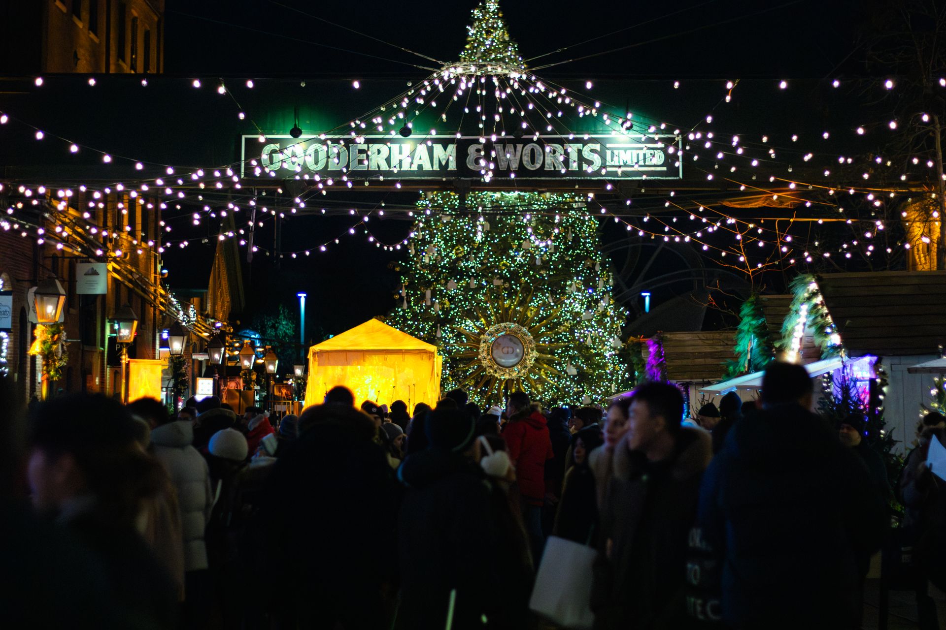 Christmas market bustle in Toronto with lights and festive decorations.
