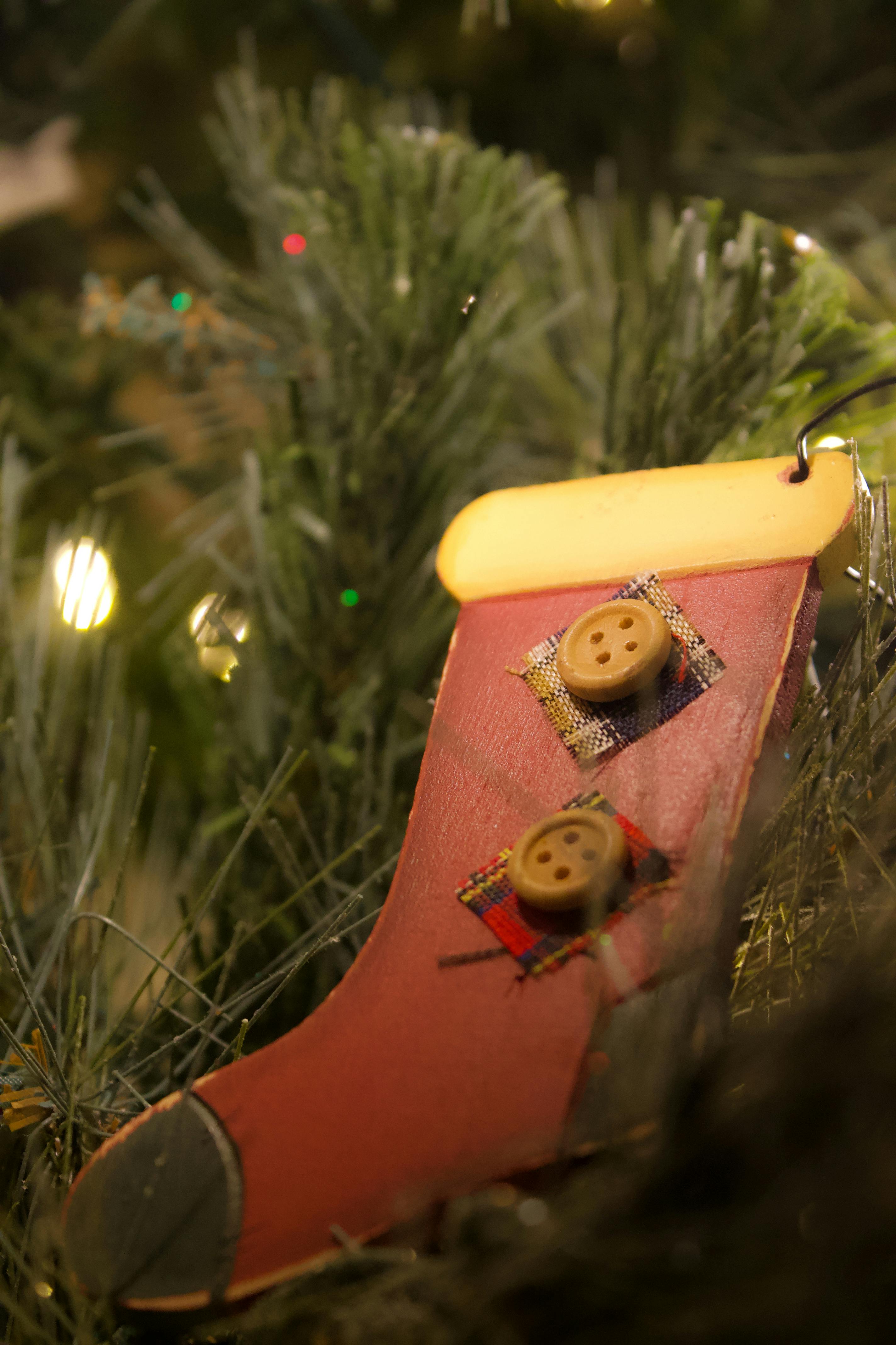 festive christmas stocking ornament on pine tree