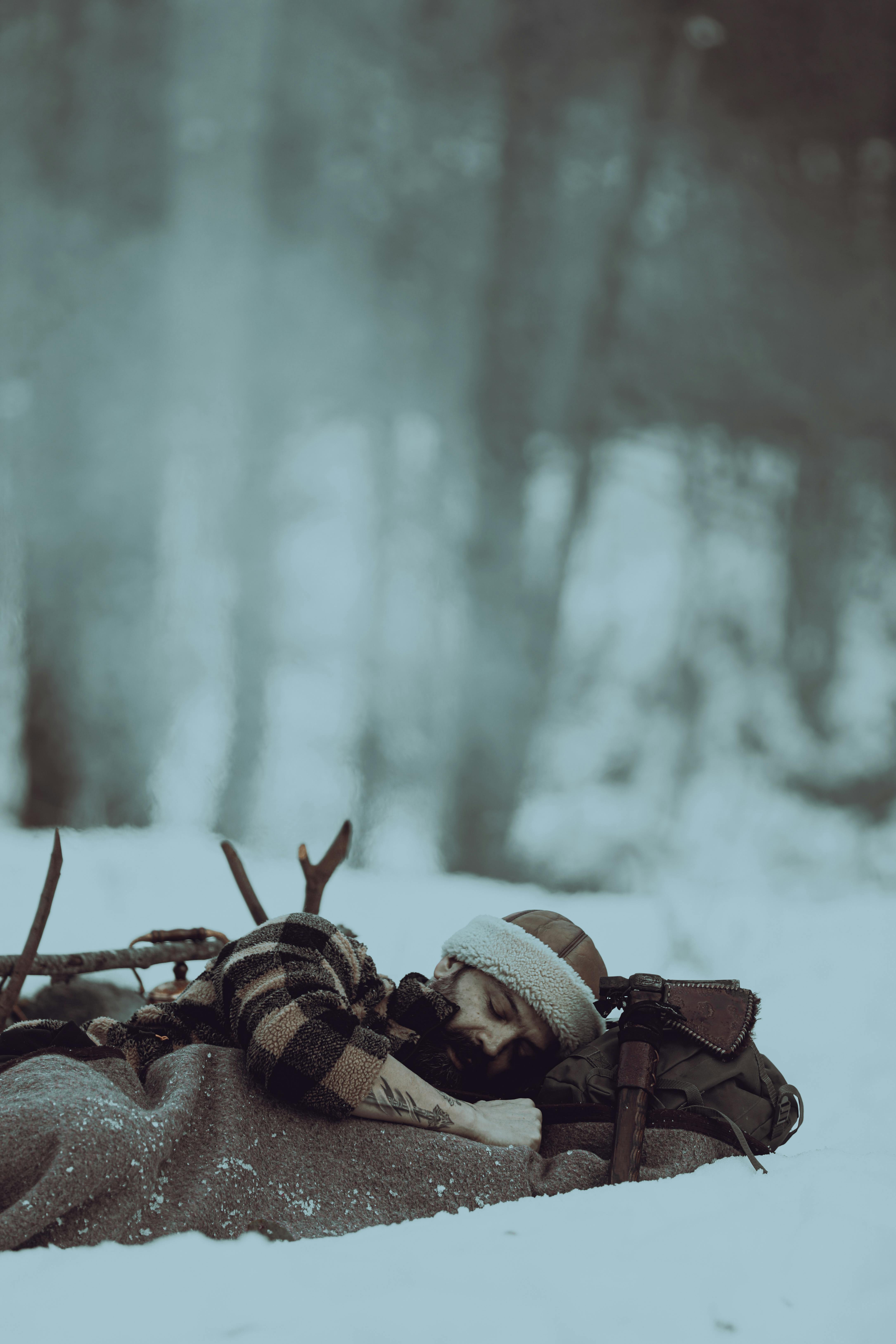 Down winter sleeping bag on a snowy campsite