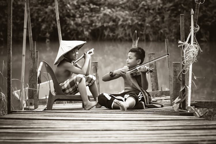 Two Boys Playing Music Instruments